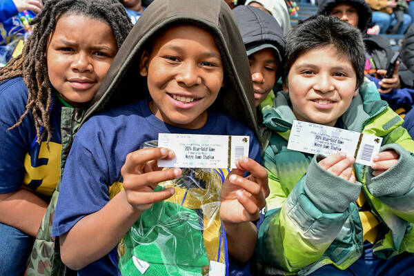 Students from two South Bend Empowerment Zone (SBEZ) schools (Coquillard and Wilson) hold up their tickets.