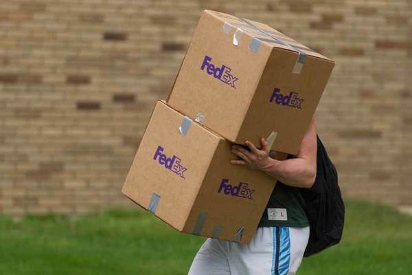 Student carrying boxes.