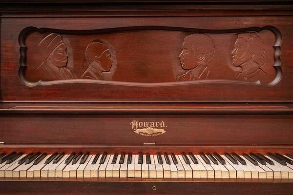 The family's heirloom is an intricately carved piano bearing a painful history of the Charles family’s legacy