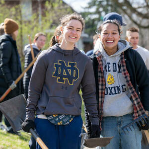 Notre Dame students spread mulch around homes in South Bend as part of Mulch Madness