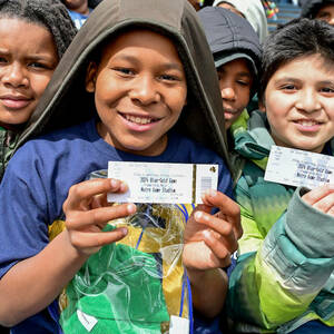 Students from two South Bend Empowerment Zone (SBEZ) schools (Coquillard and Wilson) hold up their tickets.