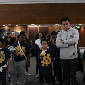 Students participate in learning activities with Notre Dame students in Heritage Hall inside the Joyce Center.