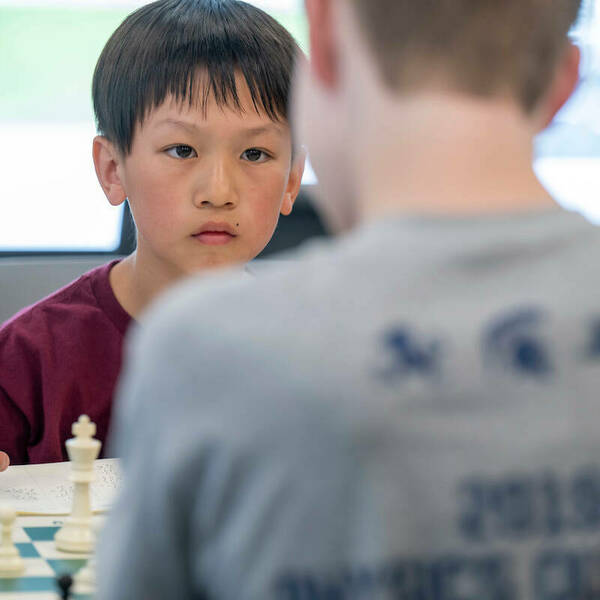 A chess tournament participant is focused during his game on April 20.